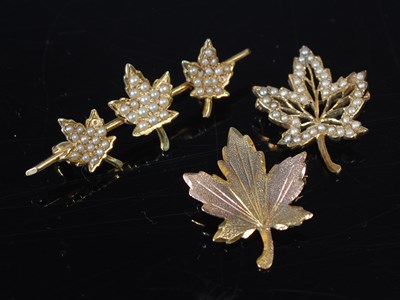 Lot 33 - A 14ct gold and split pearl triple maple leaf...