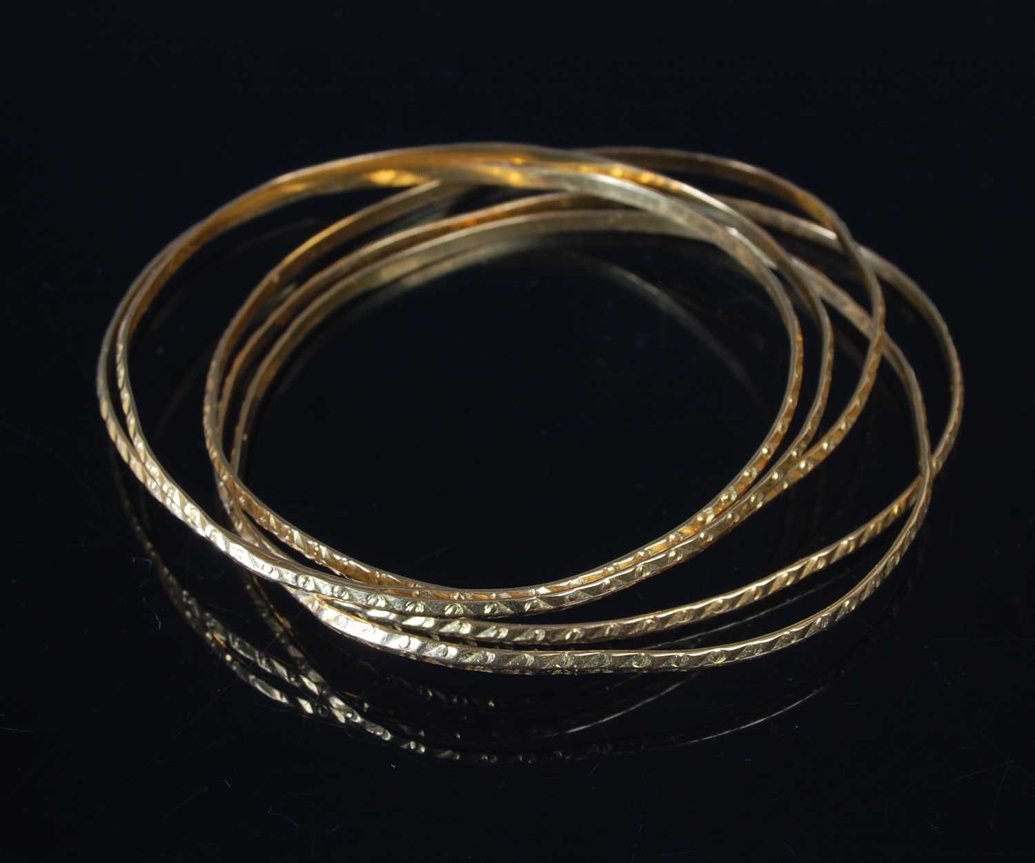 Lot 36 - Five gold bangles, each testing as 18ct gold,...