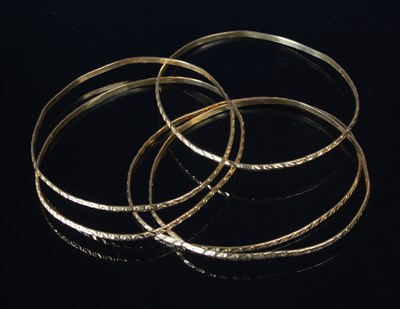 Lot 36 - Five gold bangles, each testing as 18ct gold,...
