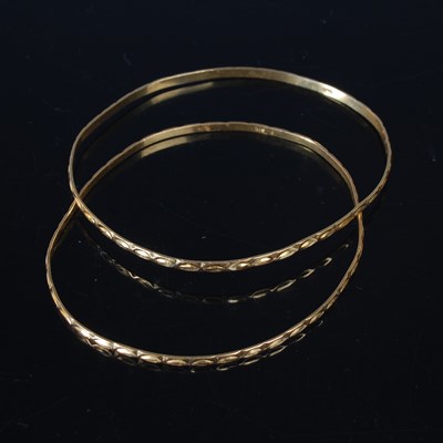 Lot 37 - A pair of gold bangles, testing as 18ct gold,...