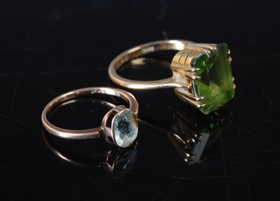 Lot 63 - Two yellow metal single stone dress rings, to...