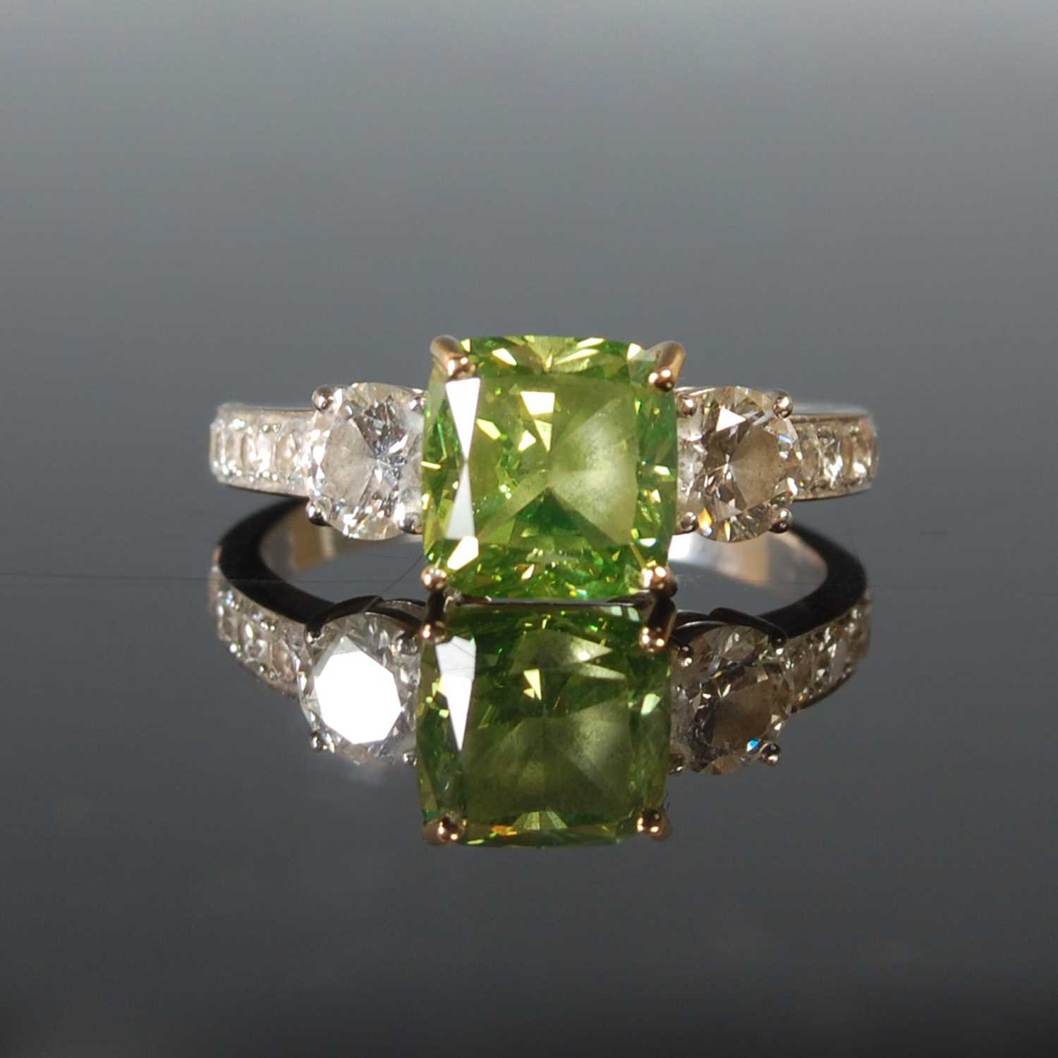 Lot 82 - An 18ct white gold enhanced green diamond and...
