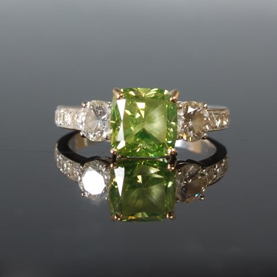 Lot 82 - An 18ct white gold enhanced green diamond and...