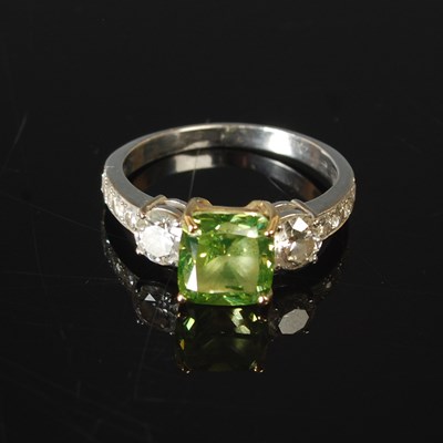 Lot 82 - An 18ct white gold enhanced green diamond and...