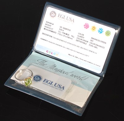 Lot 82 - An 18ct white gold enhanced green diamond and...