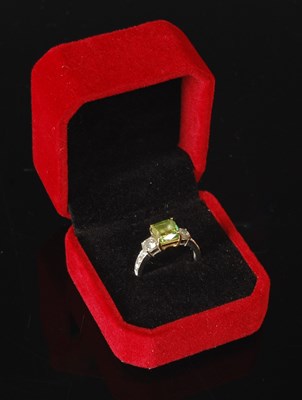 Lot 82 - An 18ct white gold enhanced green diamond and...