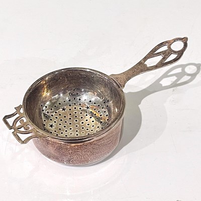 Lot 111 - A Birmingham silver tea strainer on stand, 54g.