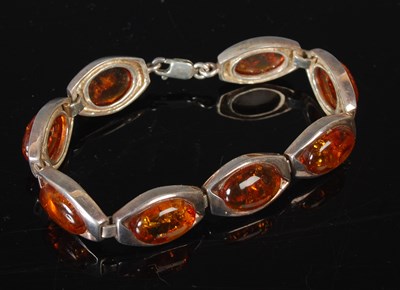 Lot 117 - A silver and amber articulated bracelet,...