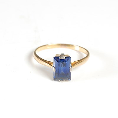 Lot 54A - A yellow metal and synthetic sapphire single...