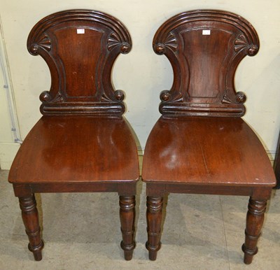 Lot 597 - A pair of 19th century mahogany hall chairs,...