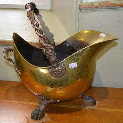 Lot 616 - A 19th century brass and copper helmet scuttle...
