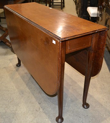Lot 630 - A 19th century mahogany drop leaf table in the...