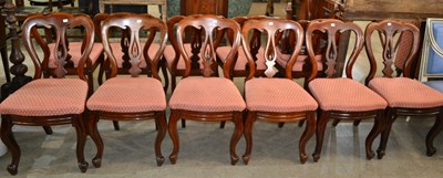 Lot 675 - A set of twelve mahogany balloon back dining...