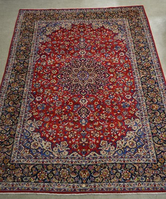 Lot 800 - A Persian Isfahan carpet, the madder coloured...