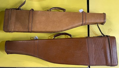 Lot 409 - Two brown leather shotgun cases, with carry...