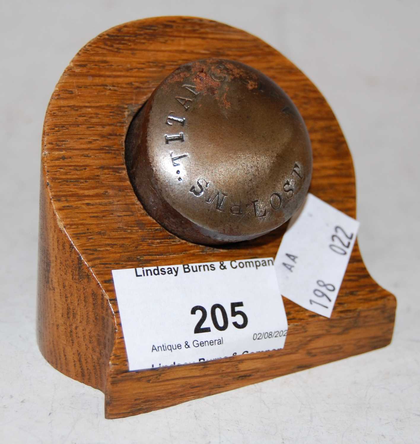 Lot 205 - Titanic interest: a metal souvenir/ rivet?...