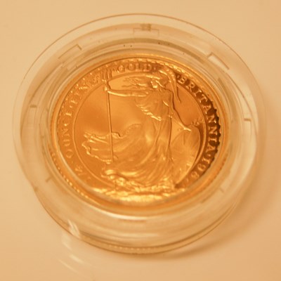 Lot 214 - A ¼ oz fine gold Britannia coin dated 1987,...