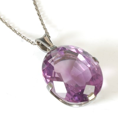 Lot 10 - An oval amethyst pendant in silver coronet...