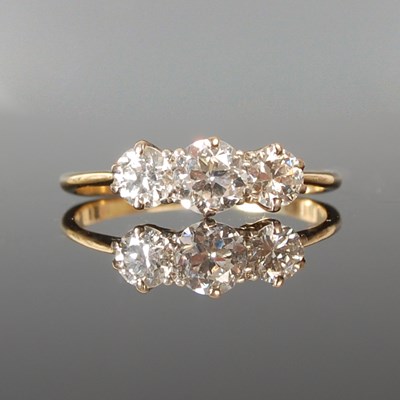 Lot 50 - A yellow and white metal diamond three-stone...