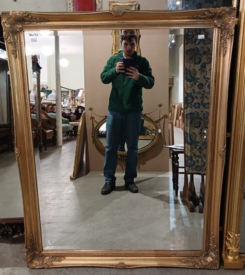 Lot 776 - A large giltwood mirror of rectangular form,...