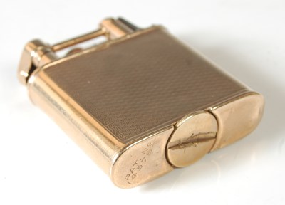 Lot 39 - A 9ct gold lighter, of rounded rectangular...