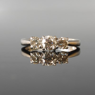 Lot 67 - A platinum and diamond three stone ring,...