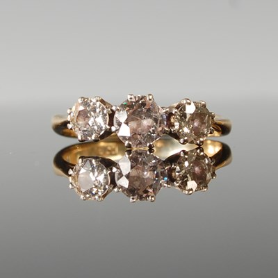 Lot 68 - A white and yellow metal three stone diamond...