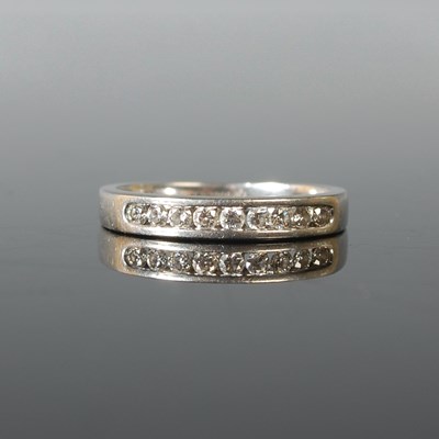 Lot 71 - A platinum and diamond half hoop ring, set...