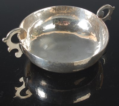 Lot 117 - An Arts & Crafts silver twin handled porringer,...