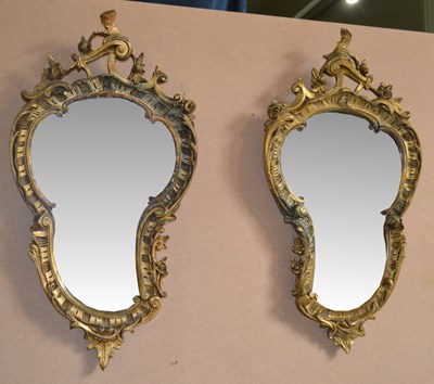 Lot 767 - A pair of Rococo style giltwood wall mirrors...