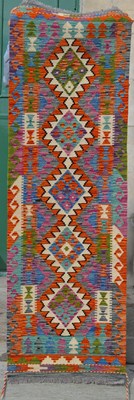 Lot 787 - A Chobi Kilim runner, the pink and blue ground...