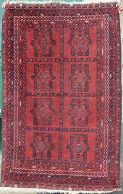 Lot 792 - An Afghan rug, the madder ground divided into...