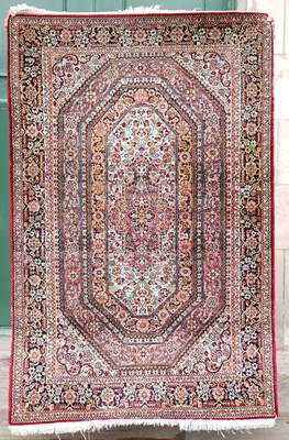 Lot 811 - A Persian silk rug, the rectangular field...