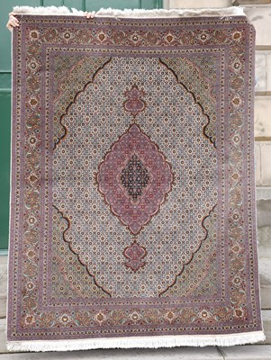 Lot 806 - A Tabriz rug, the pale blue ground centred...