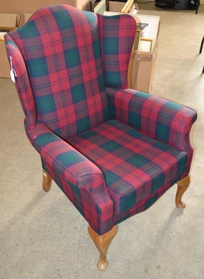 Lot 722 - A mid-20th century wing back armchair, with...