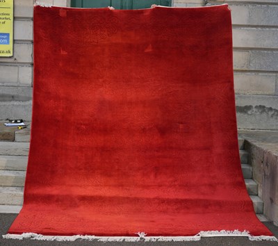 Lot 801 - A large Chinese monochrome carpet, the red...
