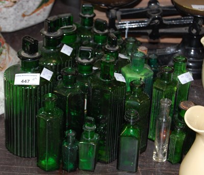 Lot 447 - A collection of various green glass apothecary...