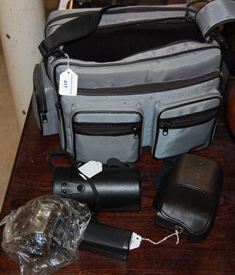 Lot 417 - A camera bag containing a Praktica BX20 camera,...