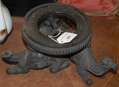 Lot 435 - A dark wood stand in the form of three...