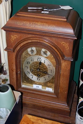 Lot 298 - A marquetry inlaid mantle clock, the brass...