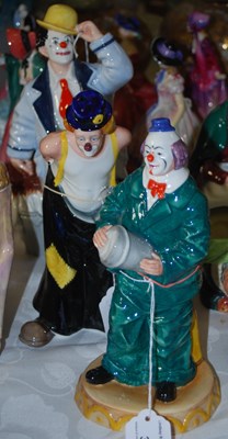 Lot 397 - A group of three Royal Doulton clown figures...