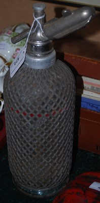 Lot 472 - A vintage Seltzer soda syphon with wire mesh...