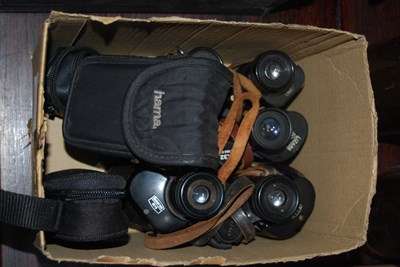 Lot 494 - A box containing four sets of binoculars...