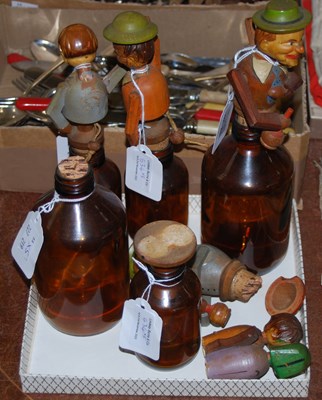 Lot 534 - A collection of carved wooden bottle stoppers...