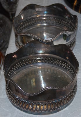 Lot 553 - A pair of white metal bottle stands.
