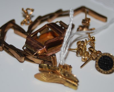 Lot 50 - A pair of yellow metal earrings in the form of...