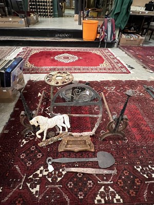 Lot 642 - A box of cast metal items to include fire dogs,...
