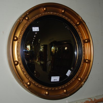 Lot 813 - A reproduction Regency style convex gilt wall...
