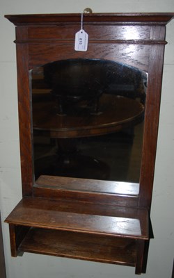 Lot 815 - An early 20th century oak hall mirror,...