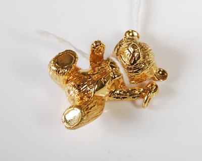 Lot 58 - A gilt metal charm in the form of a teddy bear,...